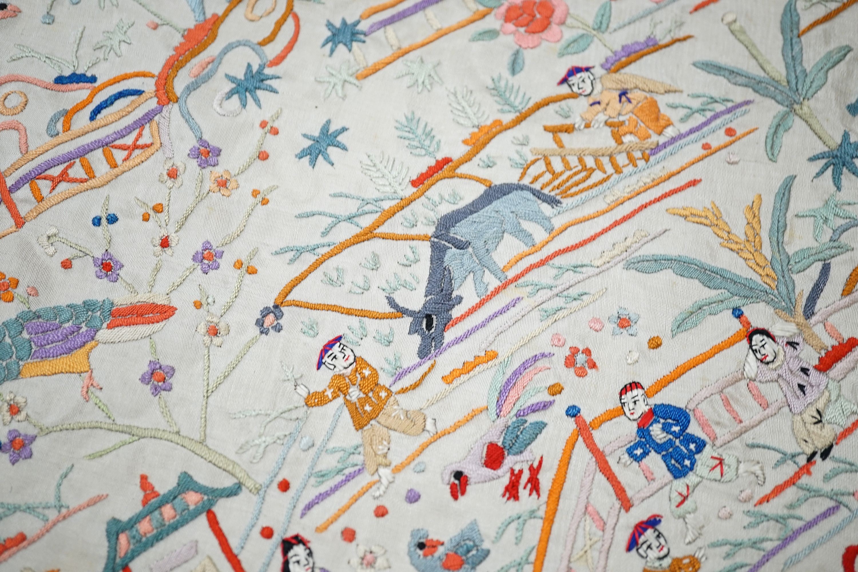 A Chinese cream silk shawl with fine multi coloured all over embroidery depicting figurative scenes and animals